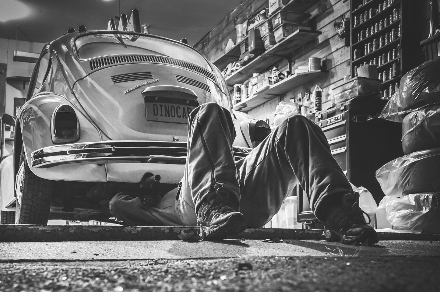 Auto mechanic working on vintage Volkswagen Beetle